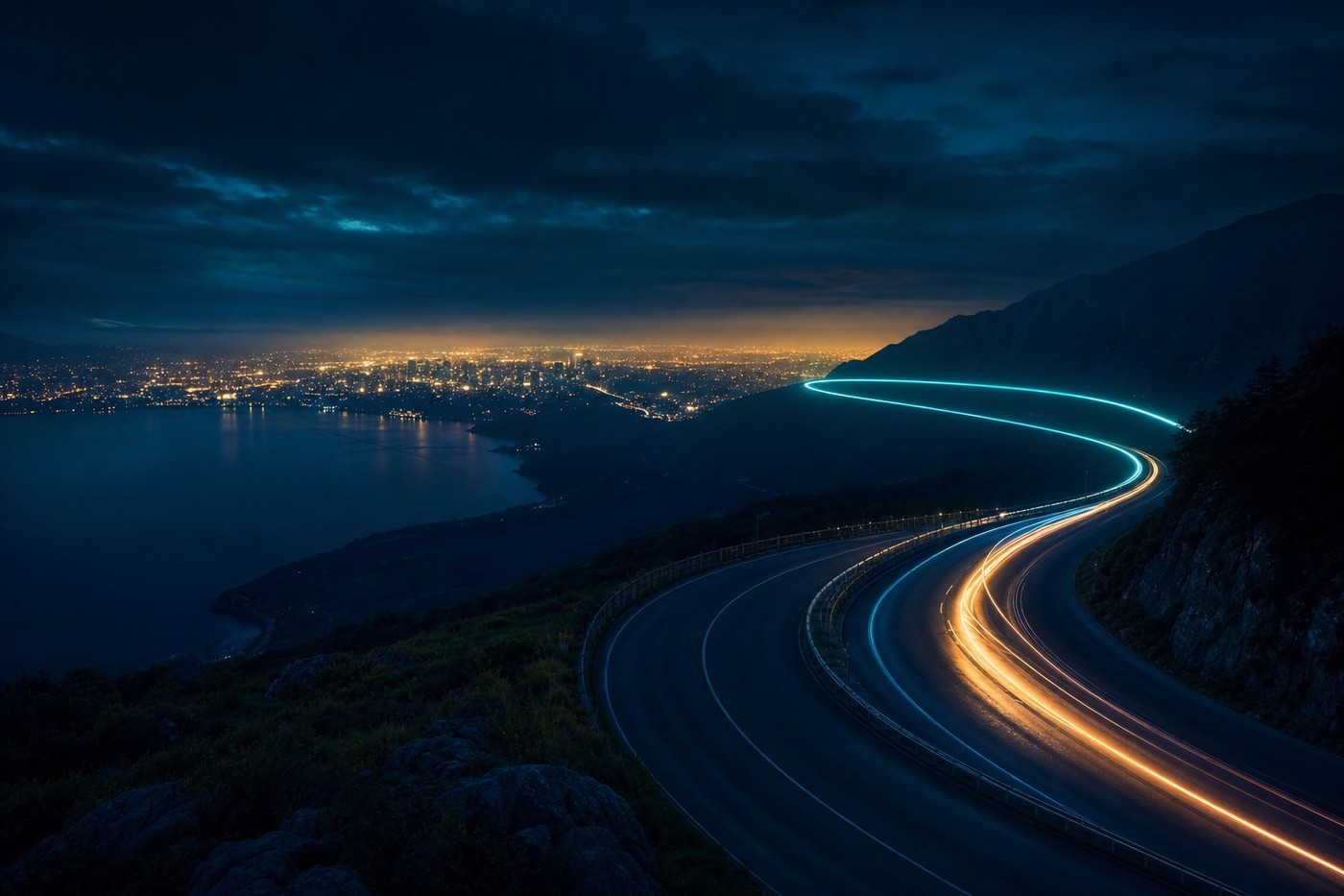 A night highway curving toward a distant city glow